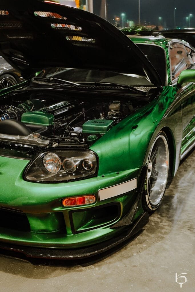 a green car with its hood open